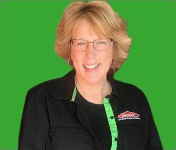 Mary Drewes female employee in front of green background